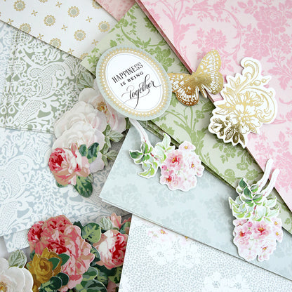 A stack of Anna Griffin | Create Crop At Home 4 scrapbooking papers adorned with vibrant flowers.