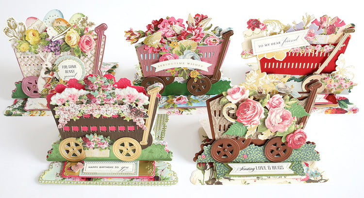 Five ornate, floral-themed pop-up greeting cards with decorative wheels and messages like "Springtime Wishes" and "Happy Birthday" displayed in a row.