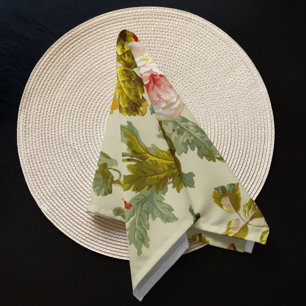 A round straw placemat paired with a Cloth Napkin Set of 4, elegantly folded into a triangle and featuring a floral pattern, enhances your dining experience against a sleek black background.