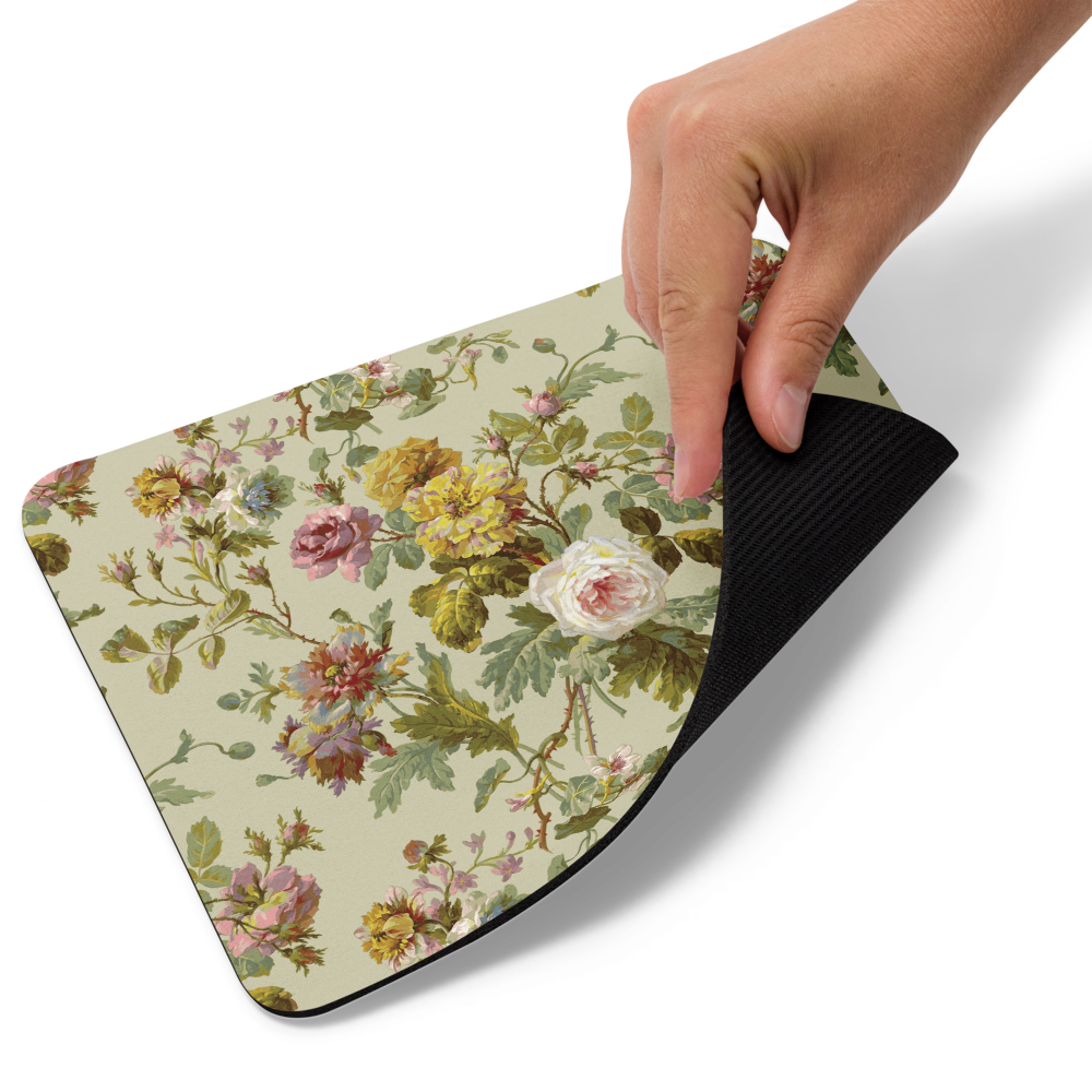 A hand lifts the floral-patterned Mouse Pad to reveal its dark, non-slip backing for excellent grip and smooth mouse movement.