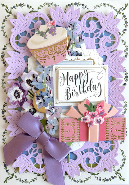 a birthday card with a cupcake and flowers.