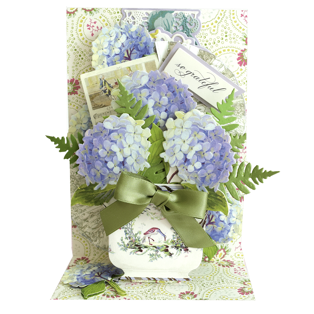 a bouquet of blue flowers in a white vase.
