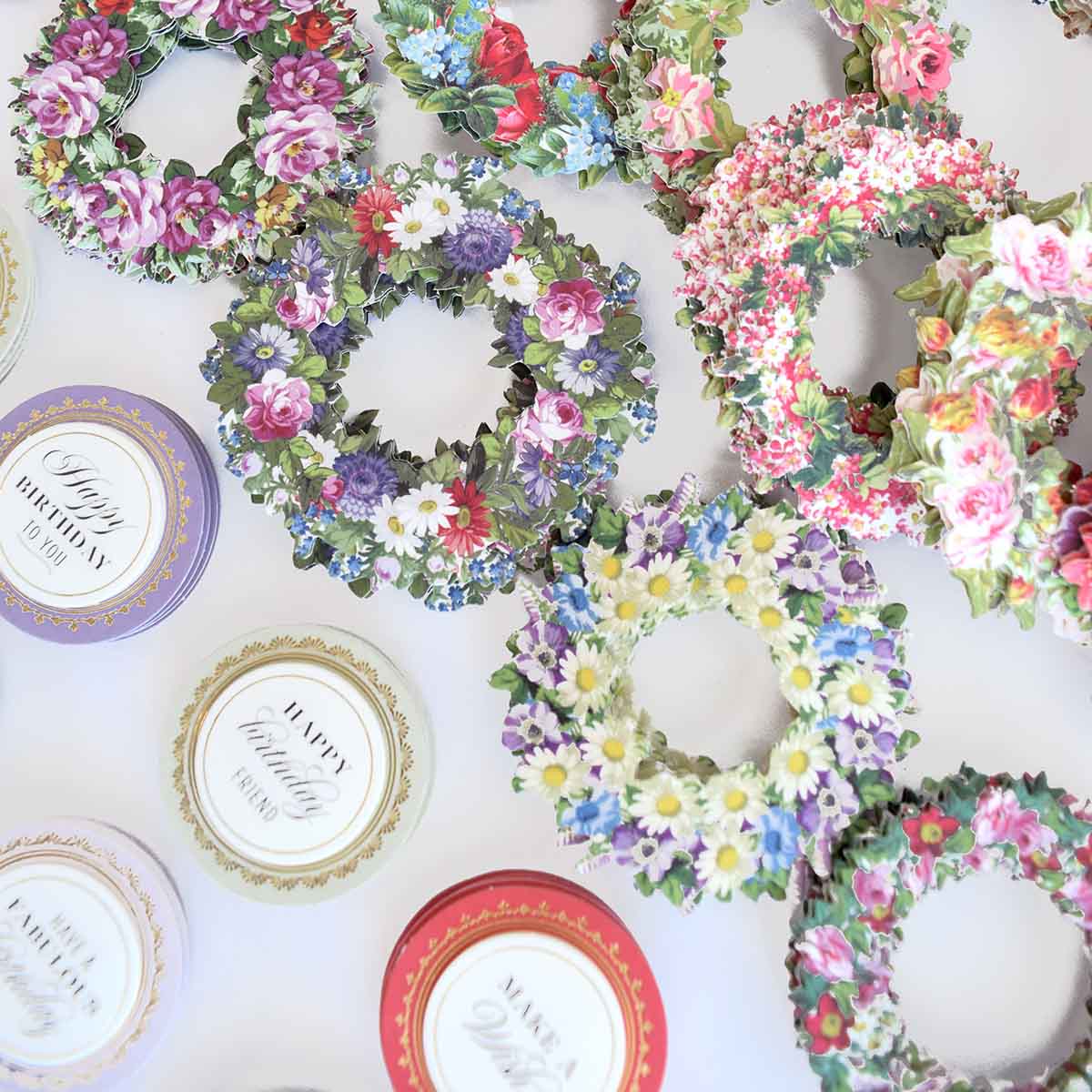 a table topped with lots of plates covered in flowers.