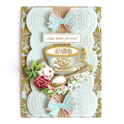 a card with a tea cup and a bow on it.