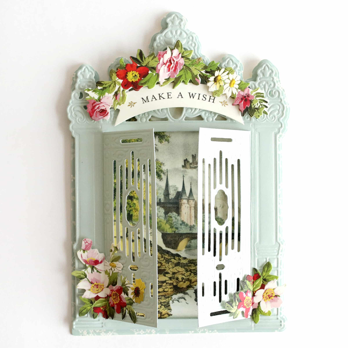 a decorative mirror with a picture of a castle and flowers on it.