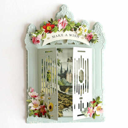 a decorative mirror with a picture of a castle and flowers on it.