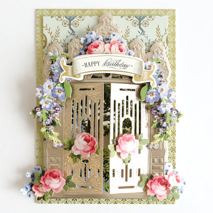 a happy birthday card with flowers and a gate.