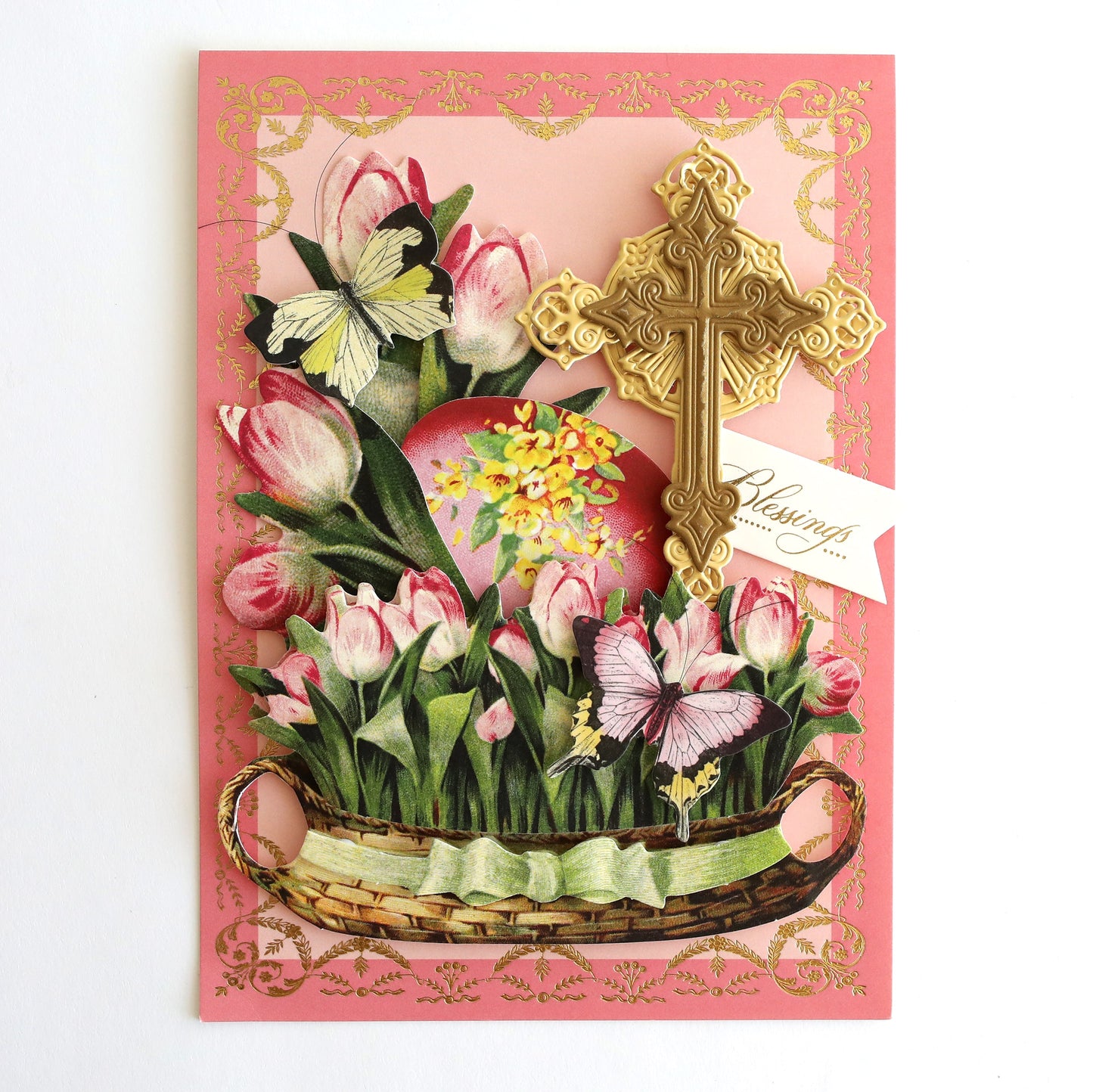 a card with a basket of flowers and a cross.
