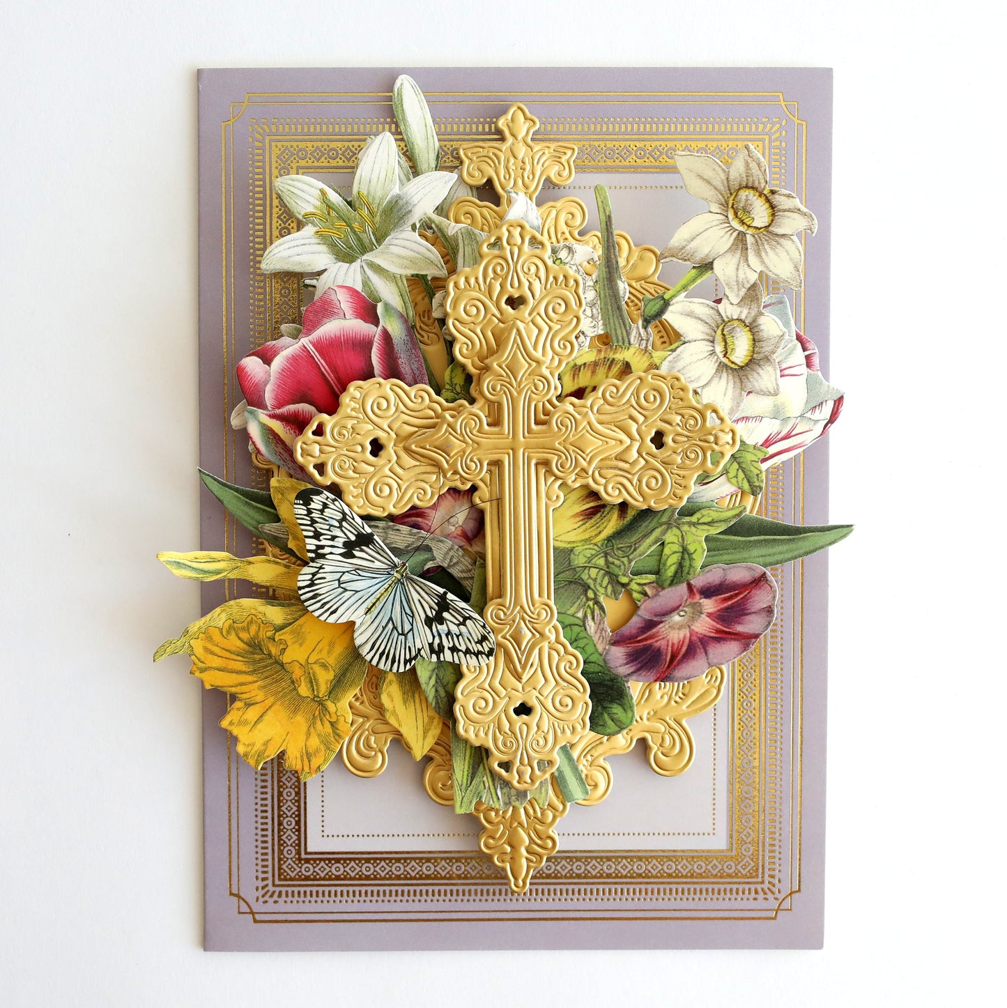 a cross made out of flowers on a wall.