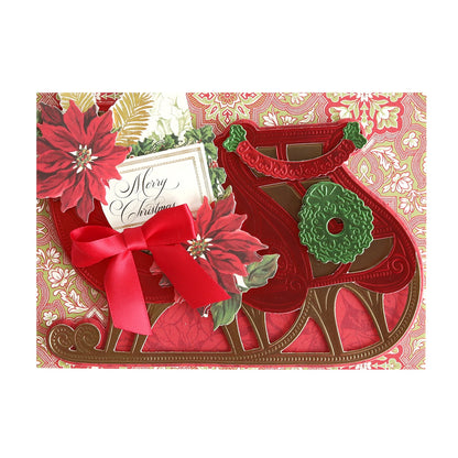 a christmas card with a 3D Sleigh Die and poinsettias.