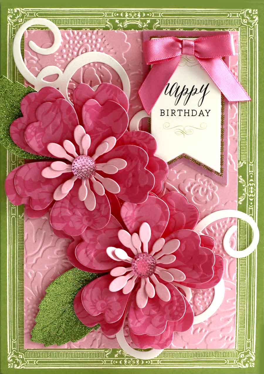 a card with pink flowers and a happy birthday tag.
