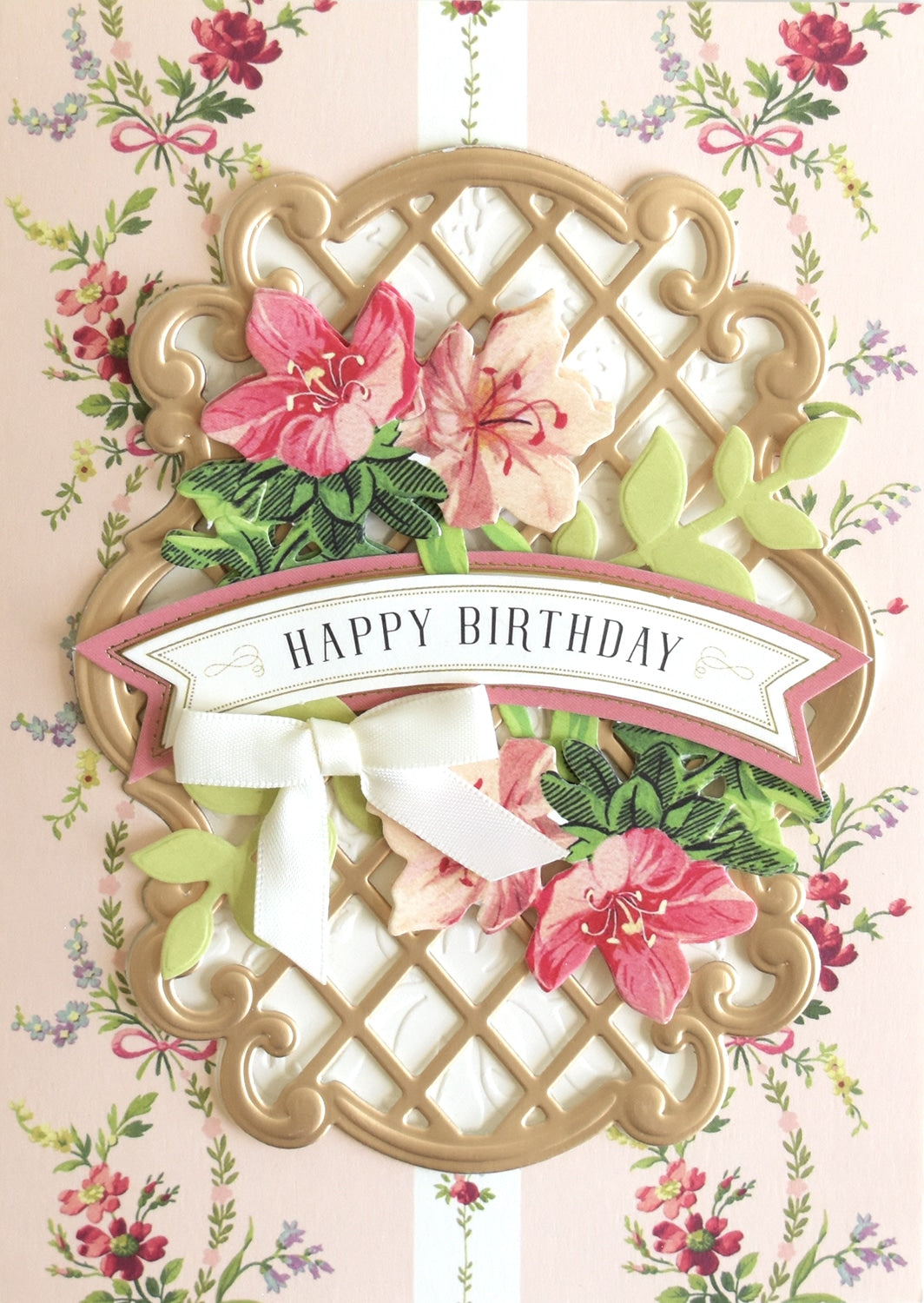 a birthday card with flowers and a ribbon.