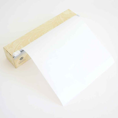 a white piece of paper sitting on top of a piece of wood.