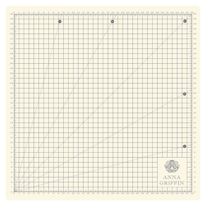 a green and white cutting mat with a line drawn on it.