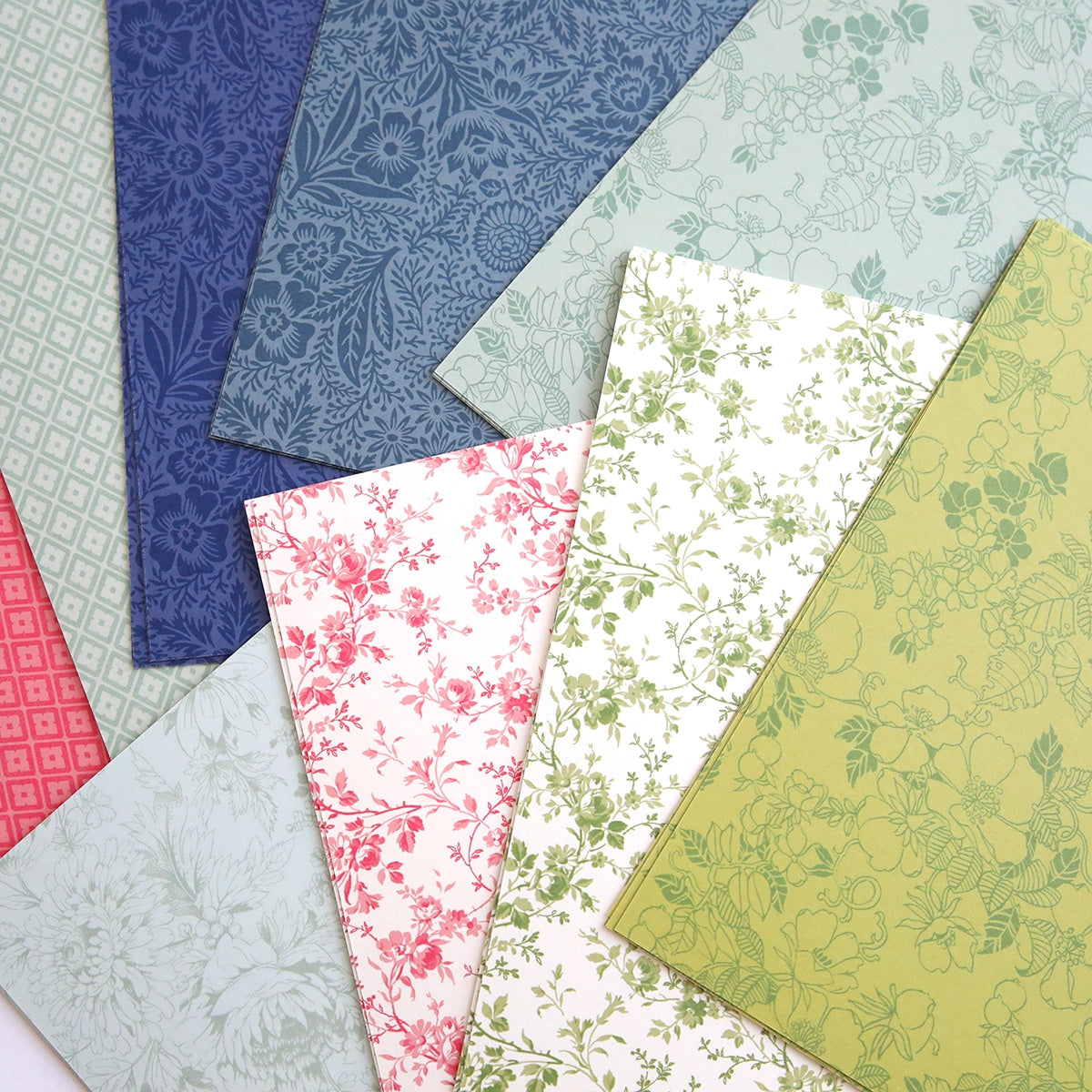A bunch of Flower Shop Double Sided Cardstock in different colors on a table.