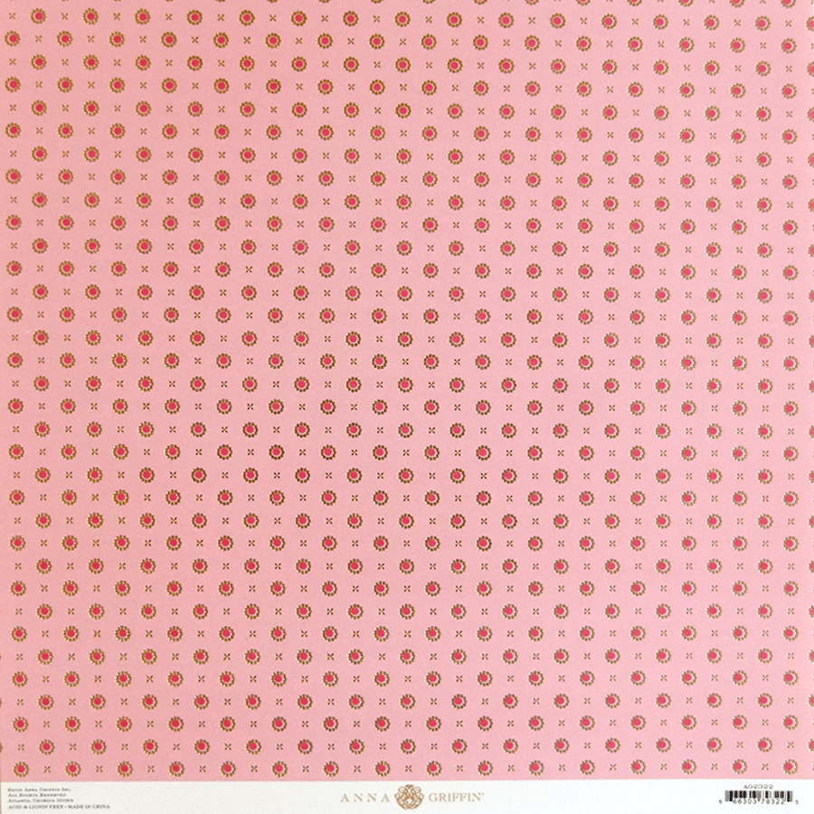 a close up of a pink background with red dots.