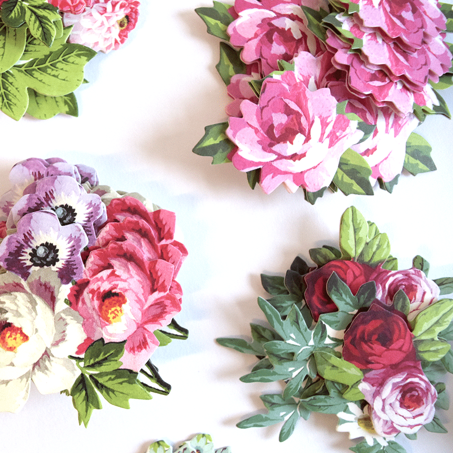 a group of paper flowers sitting on top of a table.