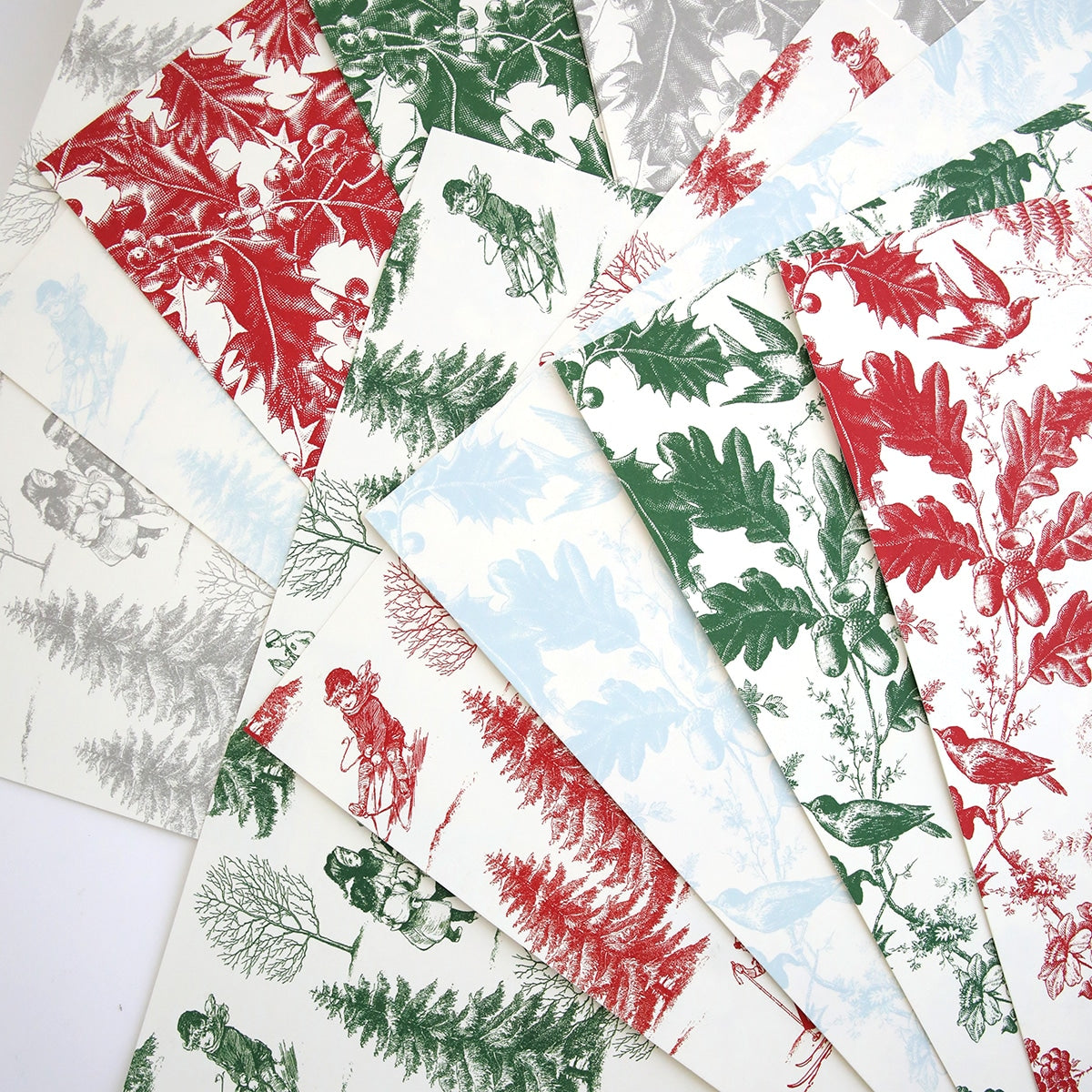 a bunch of Christmas Toile 12x12 Cardstock with red, green, and white designs.