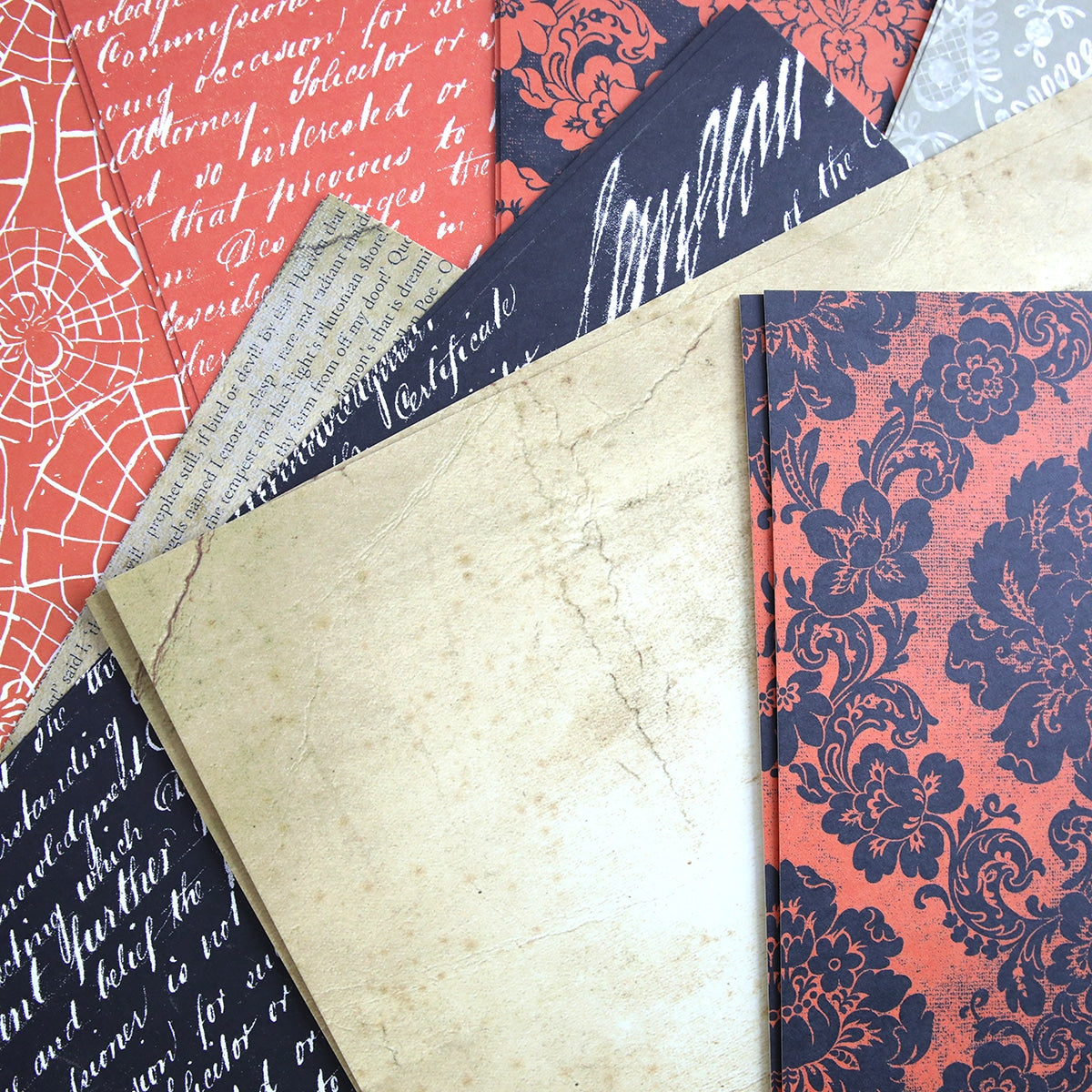 A pile of papers with Spooktacular Halloween 12x12 Cardstock designs on them.