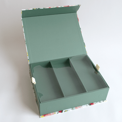 a open green box with a flowered design on it.