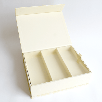 a white box with three compartments on a white surface.