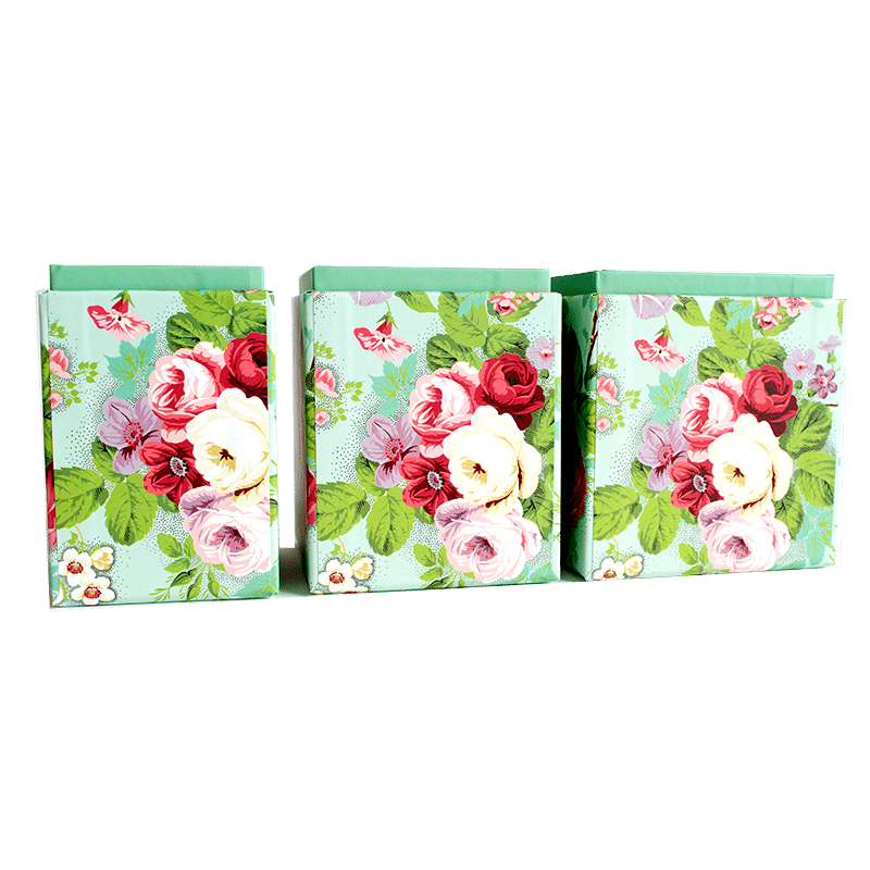 a set of three bags with flowers on them.