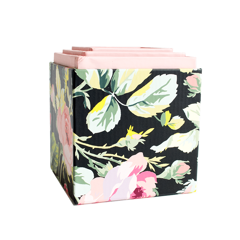 a black and pink flowered box with pink handles.