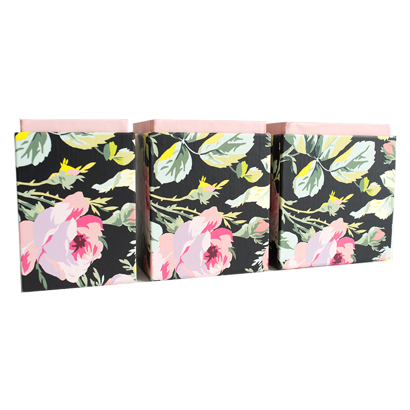 three black and pink flowers on a green background.