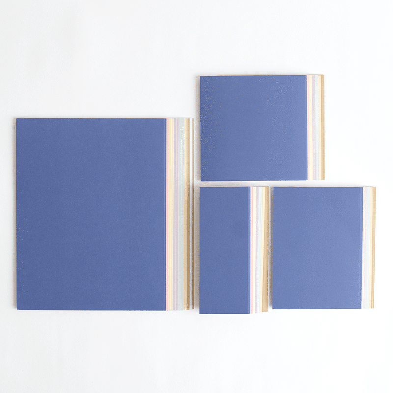three pieces of blue paper are stacked on top of each other.