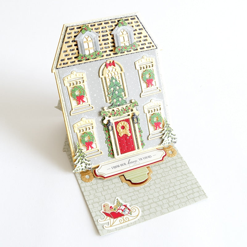 a christmas card with a house on it.