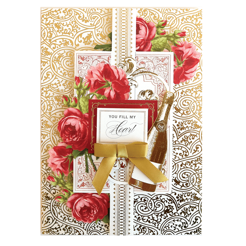 a greeting card with roses and a gold ribbon.