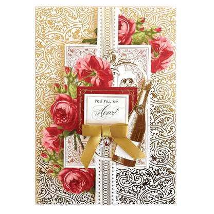 a greeting card with roses and a gold ribbon.