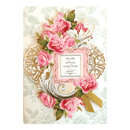 a card with pink roses and a card saying you are always close to my heart.