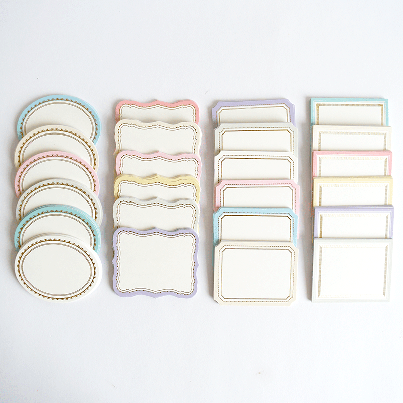 a white table topped with lots of plates and place mats.