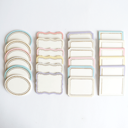 a white table topped with lots of plates and place mats.