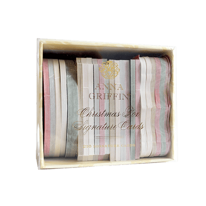 a wooden box filled with different colored ribbons.