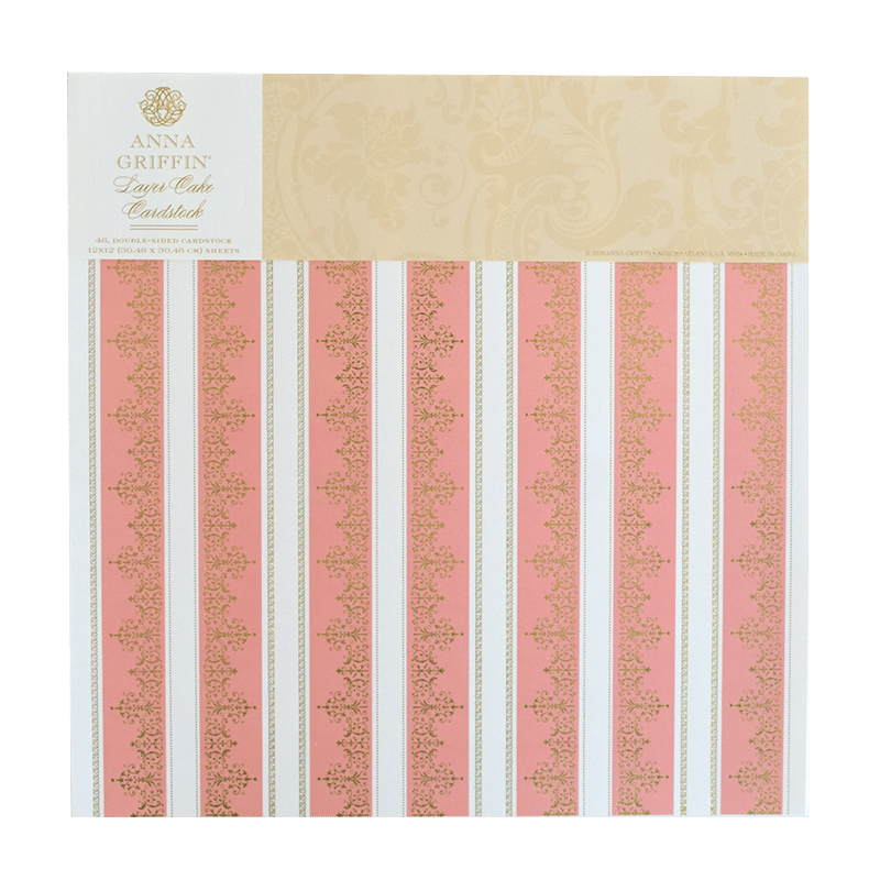 a pink and white striped paper with gold trim.