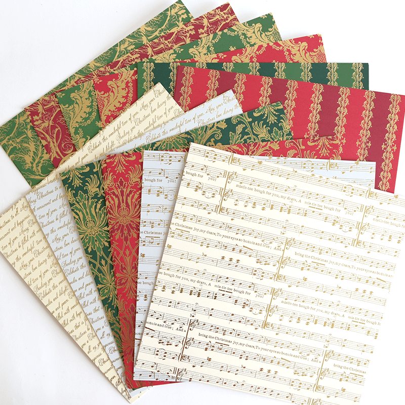 a collection of sheet music paper on a white surface.
