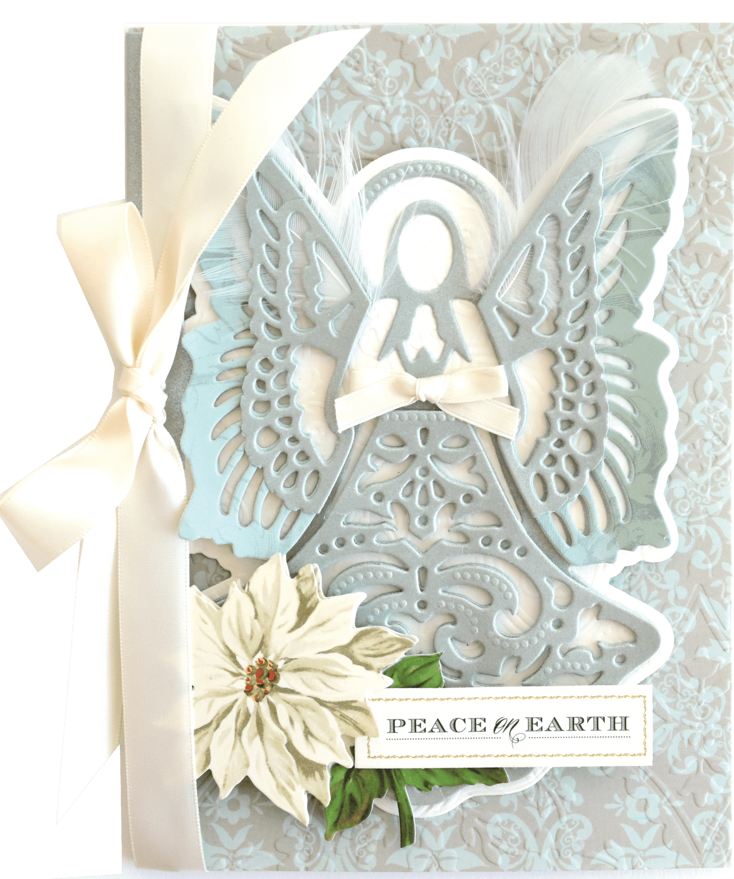a card with a white flower and a white ribbon.