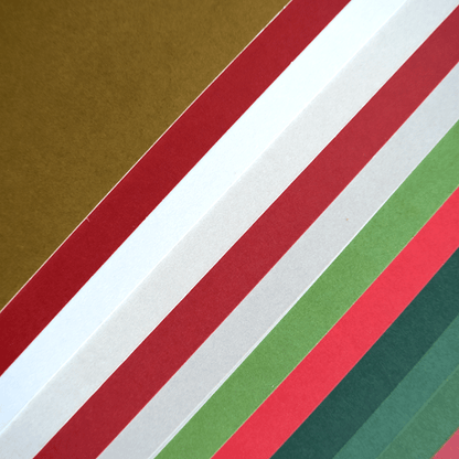 a close up of a stack of different colored papers.