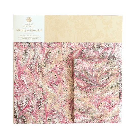 two sheets of pink and green paisley fabric.