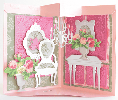 a pink card with a picture of a chair and a vase of flowers.