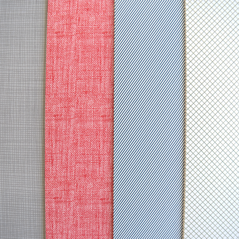 a group of different colored ties on a table.
