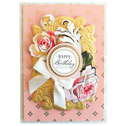 a pink and gold birthday card with flowers.