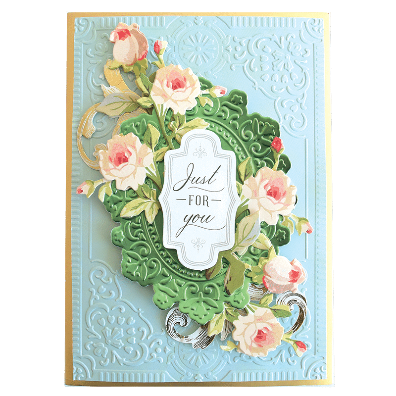 a handmade card with a floral wreath on it.