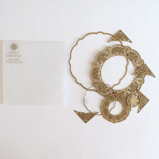 a pair of earrings sitting next to a card.
