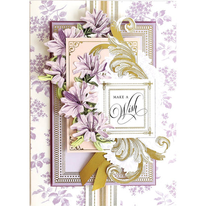 a card with purple flowers and a gold ribbon.