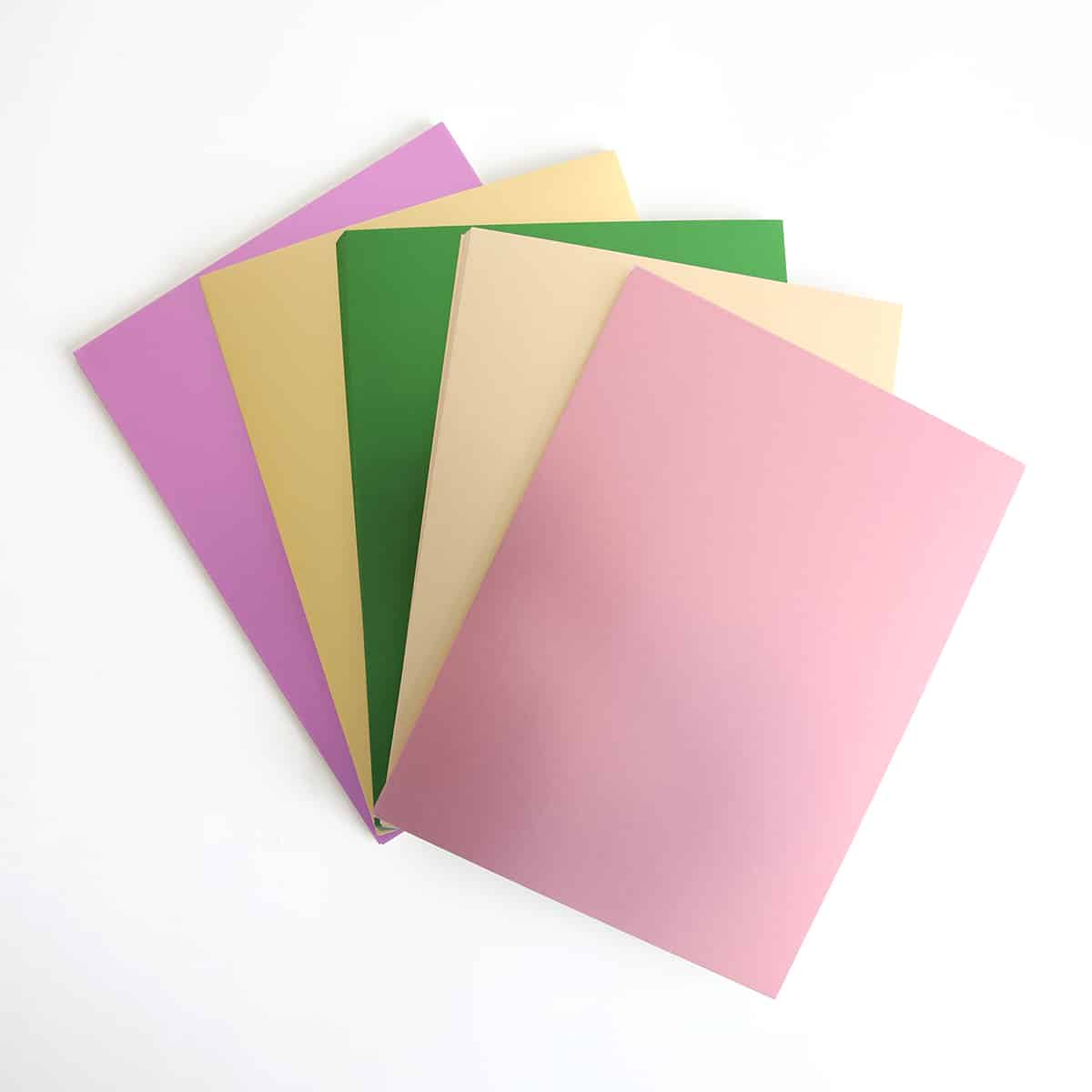 five different colors of paper on a white surface.