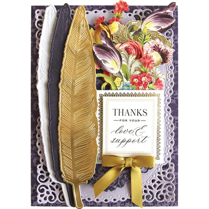 a thank card with a gold feather and flowers.
