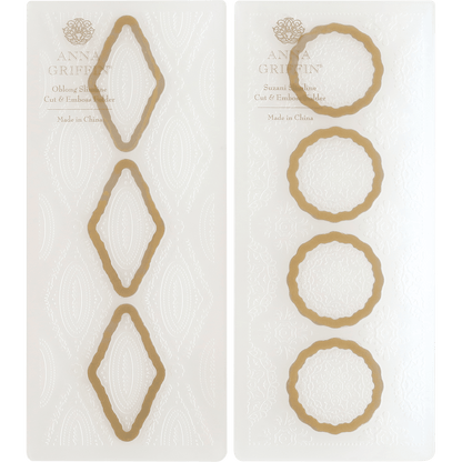 a pair of white and gold paper with circles.